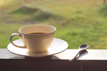 cup of coffee on wooden table