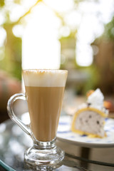 Cappuccino coffee in a tall glass. Close up shot.