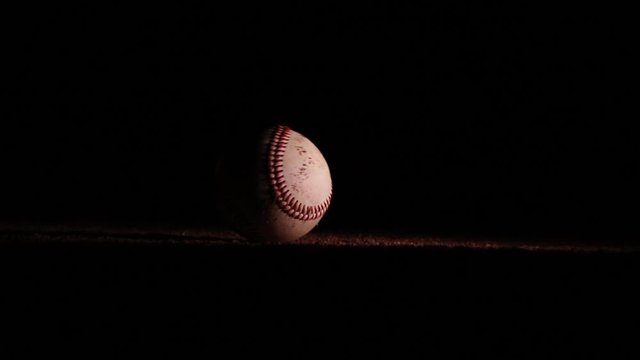 Awesome Shot of Baseball Rolling in Dirt at Night