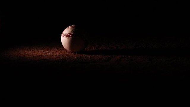 Dirty Baseball Rolls Into Stadium Lights on Mound