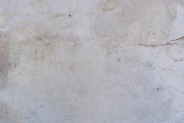 Detailed texture, background. Gray plastered wall with cracks