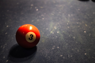Billiard ball number three on the table.