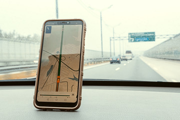 Highway view and mobile phone with map gps navigation in car