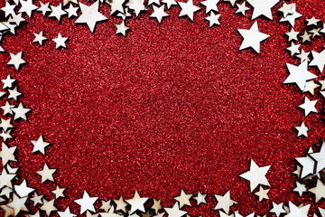 Christmas star frame over on red glitter background