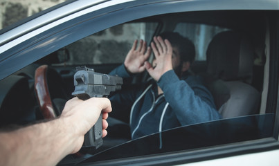 Car theft with a pistol.