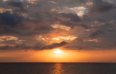 Naklejka na ściany i meble sunset time and clouds above the seascape