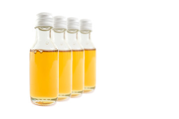 CBD Oil in glass of bottle on white background.