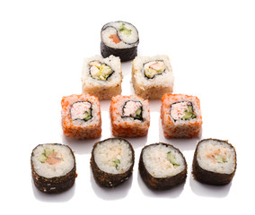 a variety of sushi rolls in the form of a Christmas tree on a white background