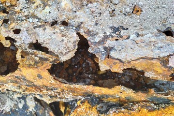 Rusted metal water pipe with partially rusted hole. Corroded metal drain sink pipe. Abstract background.