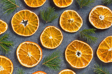 Fototapeta na wymiar Christmas winter background of dried slices of orange and branches of a Christmas tree on a dark blue background top view concept. Flat lay Happy New Year composition. Xmas mockup.