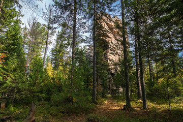 Rock in the autumn forest on the Olkha plateau