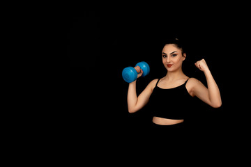 Strong looking girl doing sports on a black background