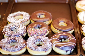 Close up Group of Glazed donuts on tray, tasty multiple assorted donut, Selective focusing on donut.