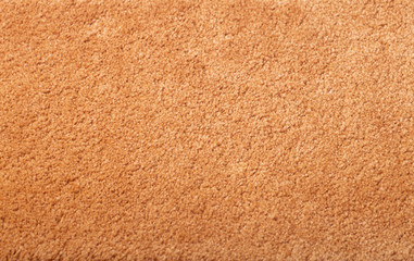 Carpet covering background. Pattern and texture of peach colour carpet. Copy space.