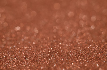 Abstract Christmast brown heart bokeh background with shining defocus sparkles. Blurred glitters shimmering dust macro close up, copy space for text logo