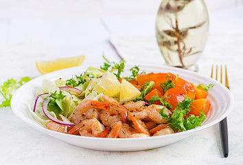 Fruit salad with fried prawns / shrimps, persimmon, red onion and lettuce in white bowls. Appetizers, snack, brunch. Healthy food.