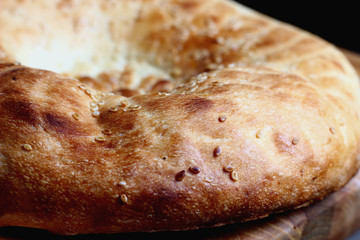 delicious bread with a golden crust sprinkled with sesame seeds