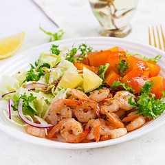 Fruit salad with fried prawns / shrimps, persimmon, red onion and lettuce in white bowls. Appetizers, snack, brunch. Healthy food.