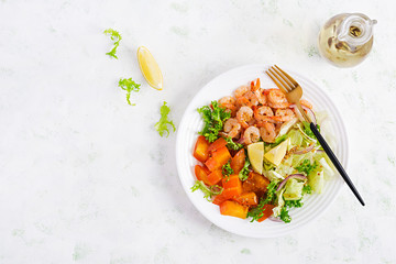 Fruit salad with fried prawns / shrimps, persimmon, red onion and lettuce in white bowls. Appetizers, snack, brunch. Healthy food. Top view, overhead, copy space
