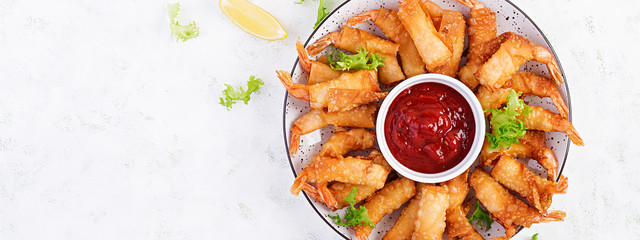 Shrimps with ginger in filo pastry with sweet and sour sauce. Thai cuisine. Deep-fried prawns. Top...