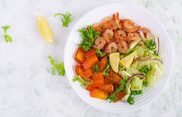 Fruit salad with fried prawns / shrimps, persimmon, red onion and lettuce in white bowls. Appetizers, snack, brunch. Healthy food. Top view, overhead, copy space