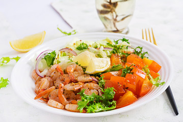 Fruit salad with fried prawns / shrimps, persimmon, red onion and lettuce in white bowls. Appetizers, snack, brunch. Healthy food.