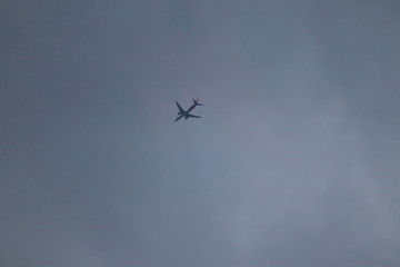 White passenger airplane in the clouds at sunset.Airplane in the sky and cloud at sunrise