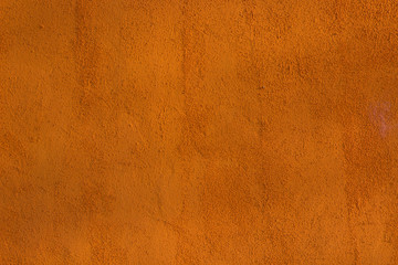 orange stucco wall with texture sunlit