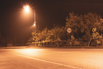 Road under tree bypass lights at night