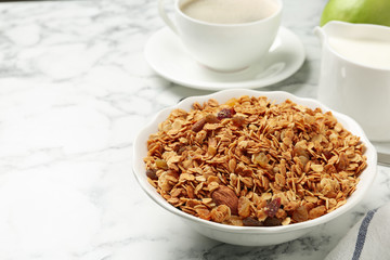 Tasty healthy breakfast with muesli on marble table