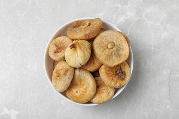 Tasty dried figs on light grey table, top view