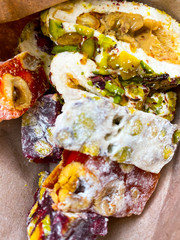 Turkish delight, sherbet, nougat on paper. National dishes. Background of sweets.