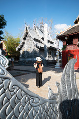 Woman tourist is sightseeing at World’s First Silver Sanctuary World’s First Silver Sanctuary, located at Wat Sri Suphan (Sri Suphan Temple), Chaingmai, Thailand.