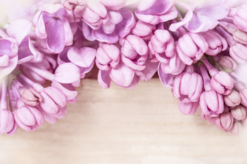 Natural floral background with blooming pink lilac close up on blurred wood. Floral desktop wallpaper or postcard with Beautiful gentle flowers. Romantic soft gentle artistic image.