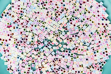 Square alphabet letter beads with multicolored characters