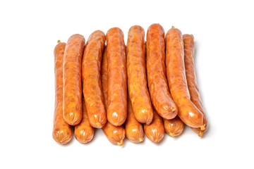 Dried pork sausages on a white plate, isolate. Sausages, dry smoked sausages, hunting sausages, kabanosy