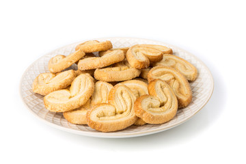 Plate full of sugar coated layered  flaky cookies