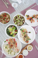 Various healthy fish and vegetables meals served on the table, healthy summer lunch	