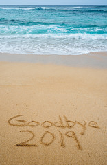 Goodbye 2019 written in the sand- New Year’s concept