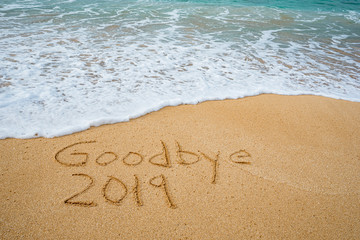 Goodbye 2019 written in the sand- New Year’s concept