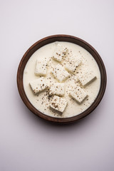 Paneer Dum Kali Mirch / Kalimirch, prepared in a white creamy gravy and black pepper powder sprinkled over it. served in a bowl. Selective focus