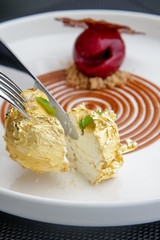 Beautiful elegant dessert in a plate. Exquisite dish with gold flakes, creative restaurant pastry concept, haute couture food	