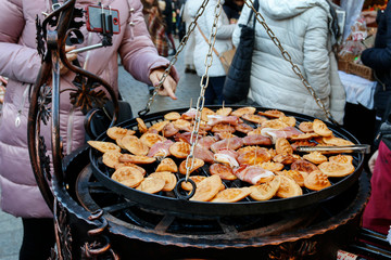 KRAKOW, POLAND - DECEMBER 05, 2019: Stall with fried cheese at the Christmas market
