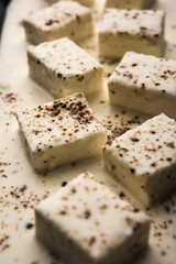 Paneer Dum Kali Mirch / Kalimirch, prepared in a white creamy gravy and black pepper powder sprinkled over it. served in a bowl. Selective focus