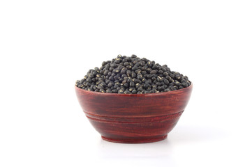 Urad dal, black gram, Vigna mungo in wooden bowl on white background