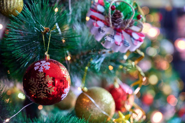 New Year and Christmas concept. Festive photo of decorations for the Christmas tree in the New Year holiday on a background of lights
