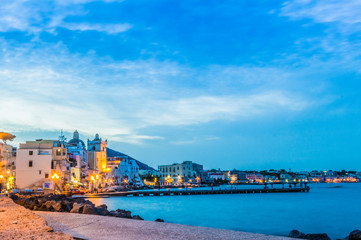 View of Ischia Island and seaside town at twilight.  Bay of water and no people, copy space. No people
