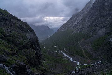 Obraz premium Norwegian mountain road. Trollstigen. Stigfossen waterfall. Norway tourist landscape valley.