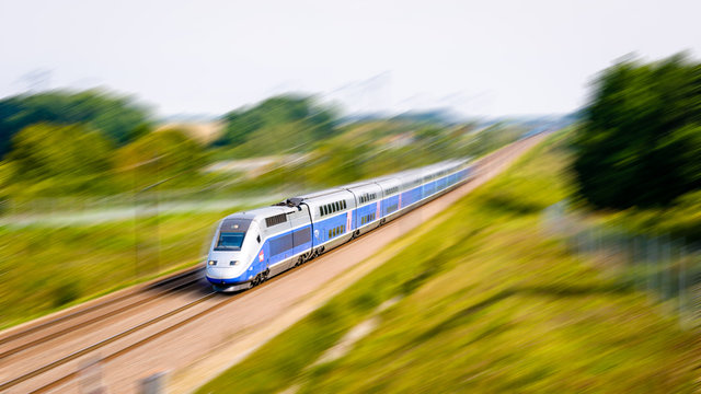 Moisenay, France - August 23, 2017: A double-decker TGV Duplex high speed train in Atlantic livery from french company SNCF driving at full speed in the countryside (artist's impression).