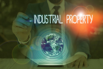 Conceptual hand writing showing Industrial Property. Concept meaning the intangible ownership of a...